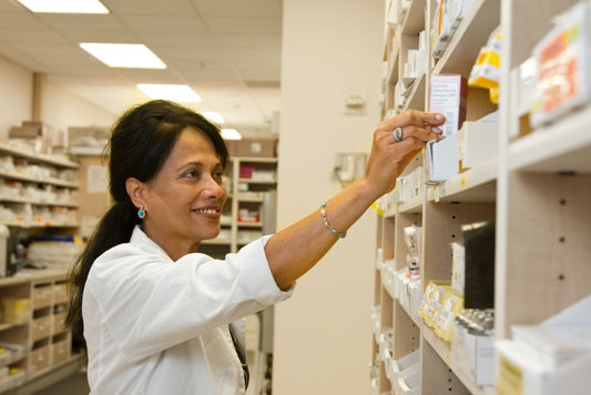 pharmacist looking at prescription 